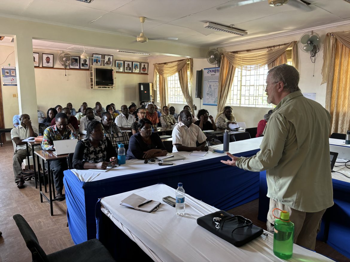 Dr. Rod Getchell leads a discussion on biosecurity and fish disease for cage farmers at Ogal Beach, Kisumu County, Kenya.